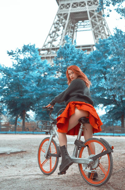 istock Sexy redhead riding through Paris 1358225079
