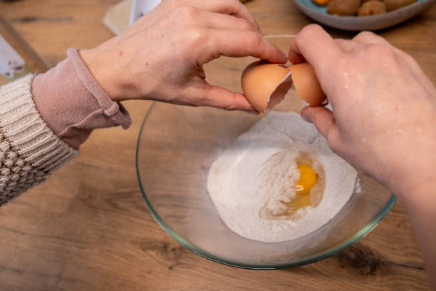 istock Hands close up of a woman cracking an egg in the home kitchen 1358225535