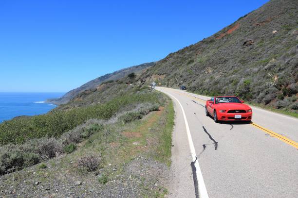 People drive along Pacific Coast Highway in California. Pacific Coast Highway is one of most recognizable scenic roads in America.