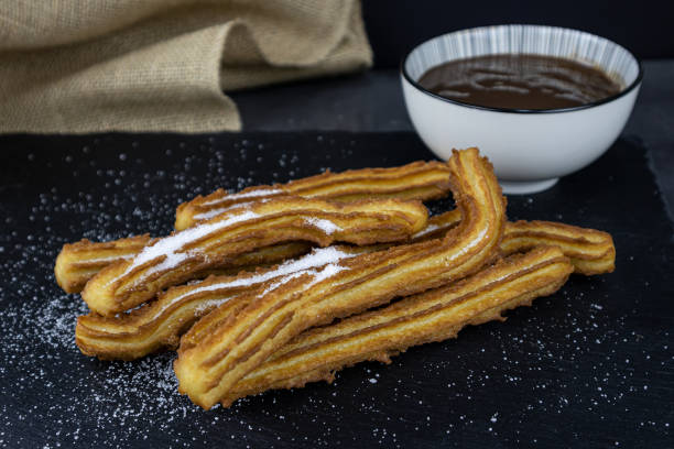 istock churros, with chocolate, sugar,  traditional recipe 1358226833
