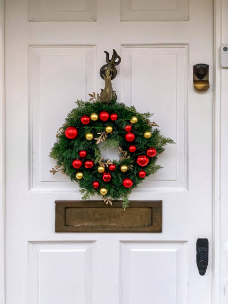 istock Christmas wreath on white door 1358228325
