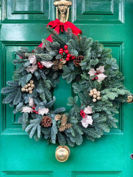 istock Christmas wreath on green door 1358228367