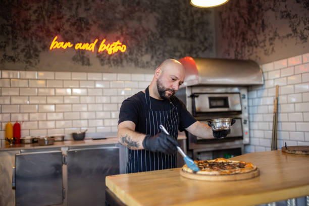 istock For final touch, chef smear the oil on the pizza crust 1358228468