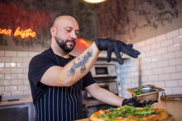 istock For a final touch, pizza master adding the arugula on the top of the pizza 1358228516