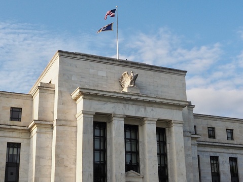 Washington D.C., District of Columbia, United States - August 31 2021: The Federal Reserve Bank headquarters building in Washington with flags and eagle.