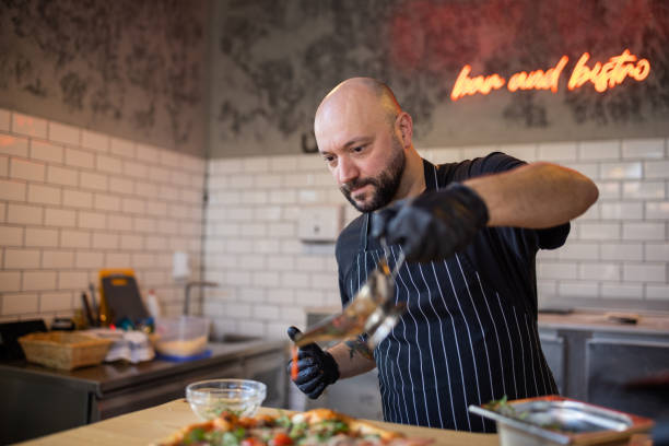 istock On the pizza, chef pouring tomato sauce 1358228909