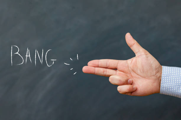 istock man hand makes a shooting gesture with her hand, the inscription BANG on a chalkboard 1358228953