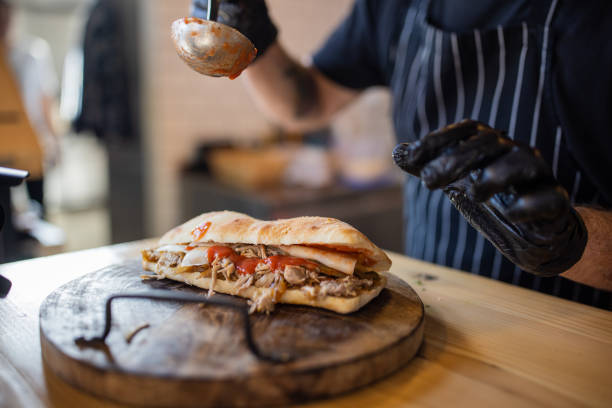 istock Unrecognizable chef, making the juicy beef sandwich 1358230406