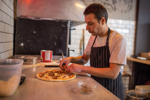 istock In the kitchen, skilled Caucasian chef making pizza 1358231657