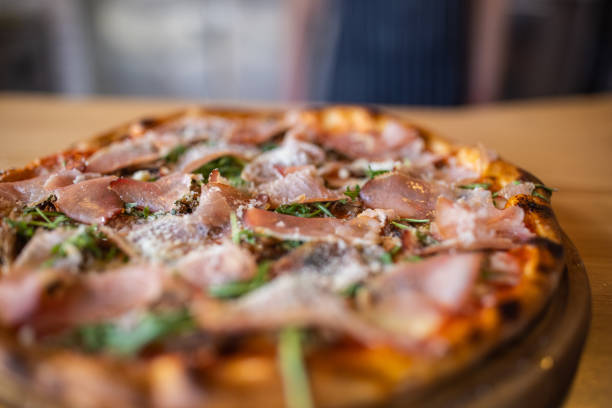 istock Pizza with nice crust and prosciutto, parmesan and arugula 1358231863