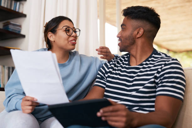istock Shot of a young couple discussing their bills while using a digital tablet 1358236239