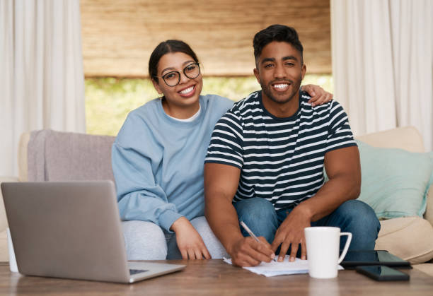 istock Shot of a young couple signing documents together 1358236263