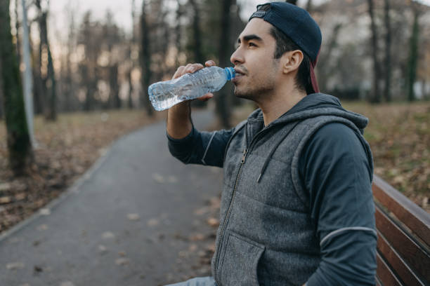 istock Young men is resting after jogging in the park 1358236913
