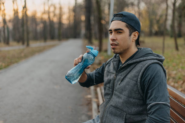 istock Young men is resting after jogging in the park 1358236935
