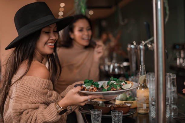 istock A waiter serving food whilst working in a trendy restaurant 1358237245