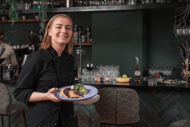 istock A waiter serving food whilst working in a trendy restaurant 1358237272