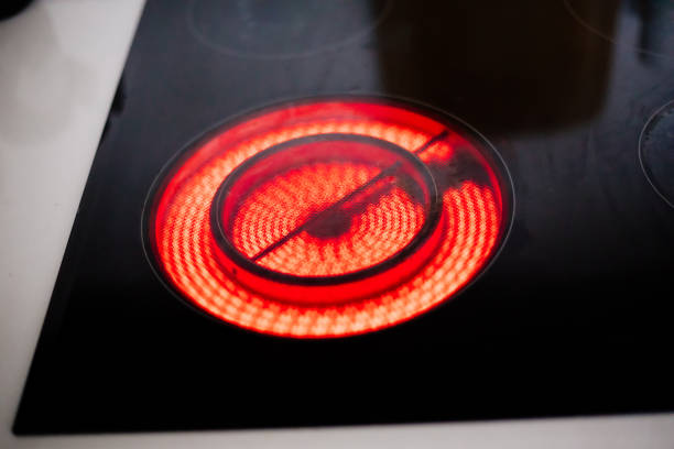 istock Electric ceramic hob with red hot plate 1358237416