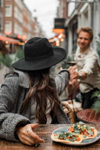 istock Happy friends sharing al fresco tacos in a restaurant setting 1358237771