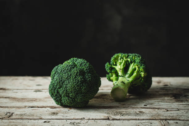 istock Fresh broccoli florets on a wooden table 1358239083