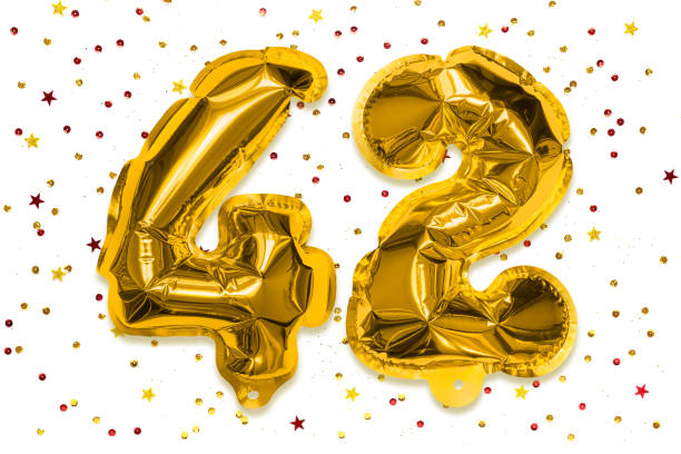 The number of the balloon made of golden foil, the number forty two on a white background with multicolored sequins. The number of the balloon made of golden foil, the number forty two on a white background with multicolored sequins. Birthday greeting card with inscription 42. Numerical digit, Celebration event. number 42 stock pictures, royalty-free photos & images