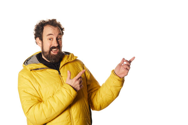 istock Bearded man in outerwear pointing away 1358240457