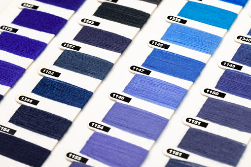 Various blue and violet trendy color of the year 2022 hue yarn thread sample swatches close-up