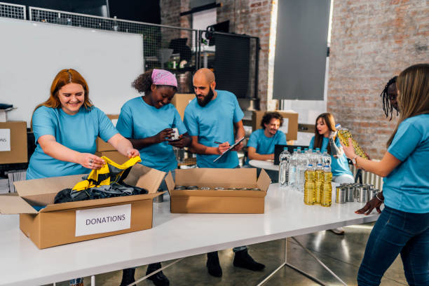istock Diverse volunteers team packing donation boxes 1358241812