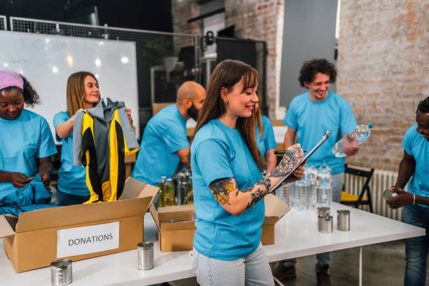 istock Young volunteers separating donations stuffs 1358243040