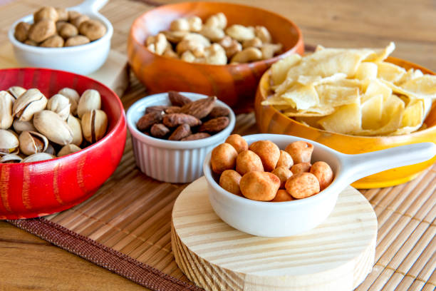 istock Healthy snack, beans, cassava chips, pistachios, Brazil nuts, chickpeas, peanuts and almonds. 1358244123