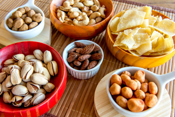 istock Healthy snack, beans, cassava chips, pistachios, chickpeas, peanuts and almonds. 1358244341