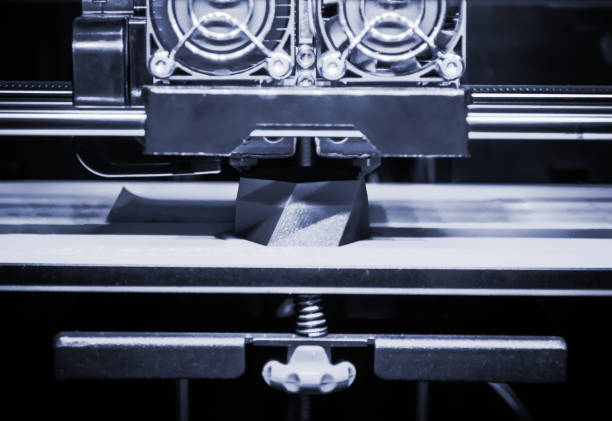 istock 3D printer works and creates an object from the hot molten plastic 1358244816