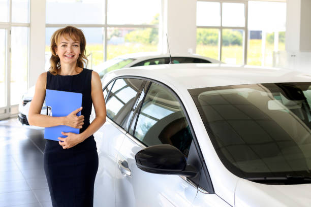 istock Car saleswoman 1358246581