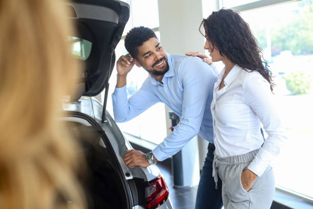 istock Couple buying a hatchback 1358247065