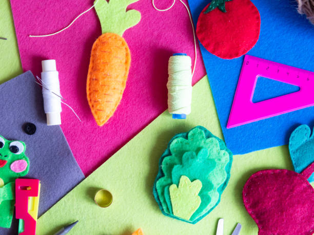 istock Hobby and colorful felt crafts. Workspace view. Sheets and crafts made of felt, scissors, threads and a needle for needlework. 1358247097