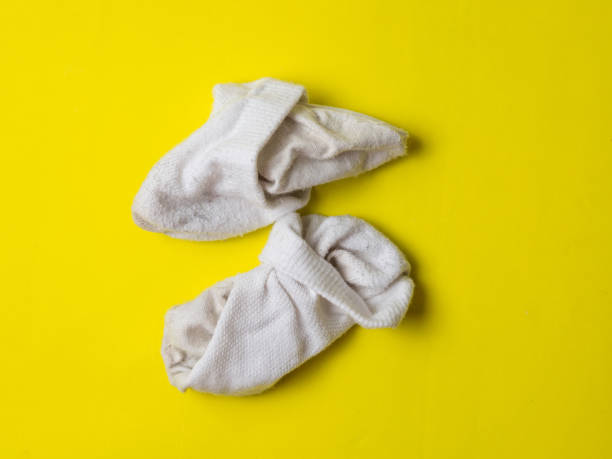 istock crumpled white dirty socks on yellow background 1358247116