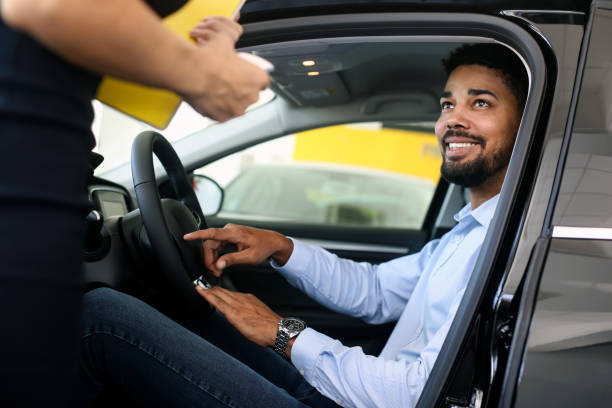 istock Man buying a new car 1358247159
