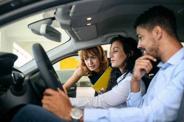 istock Couple testing a new car in a dealership 1358248226