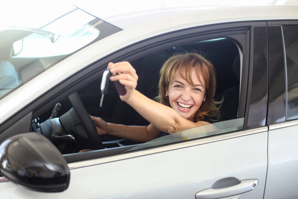 istock Woman in her new car 1358248449