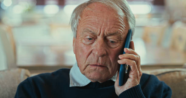 istock Shot of a senior man sitting alone on the sofa at home and looking concerned while using his cellphone 1358249308
