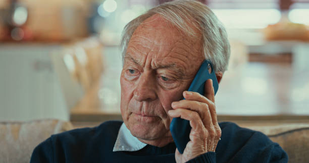istock Shot of a senior man sitting alone on the sofa at home and looking concerned while using his cellphone 1358249311