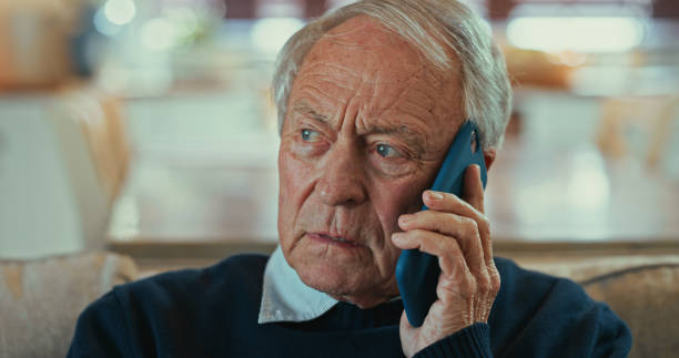 istock Shot of a senior man sitting alone on the sofa at home and looking concerned while using his cellphone 1358249313