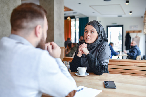 Modern Female With Hijab During Job Interview With Bearded Male