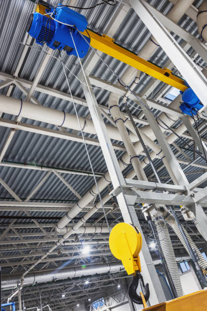 istock Crane hook inside factory building, industrial 1358251040
