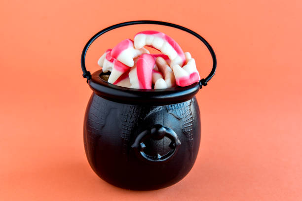 istock Happy Halloween decoration on orange background. Halloween Cauldron. 1358253497