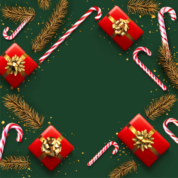 istock Striped candy cane sticks with golden spruce branch and gift box. 1358253549