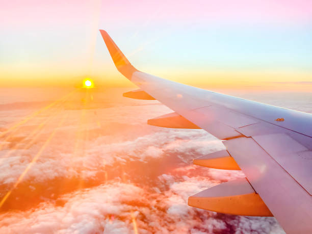 istock Airplane wing in the sky at beautiful sunset 1358253641