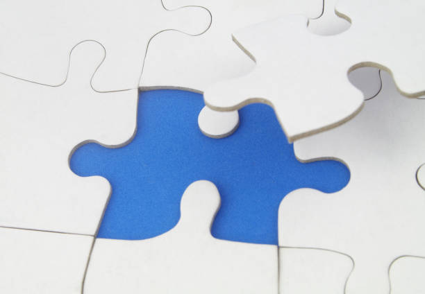 istock White jigsaw puzzles background, one piece missing and ready to connecting. 1358253957