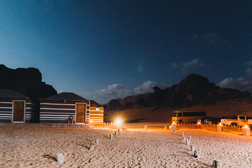 Scenic view of the night campsite with lights hidden in the rocks in the desert of Jordan
