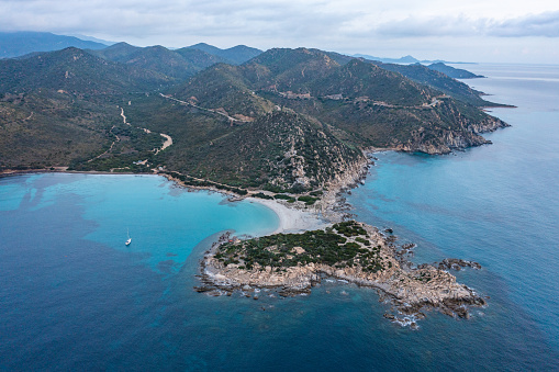 View of blue clear beach and coast in Sardinia, Italy\nDrone aerial shot.