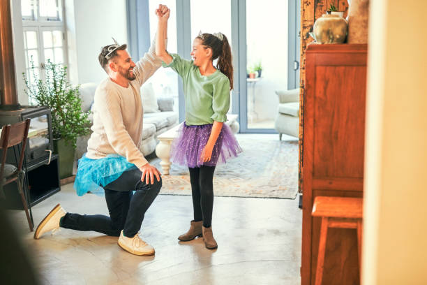 istock Shot of a father and daughter practicing a dance routine together at home 1358256553